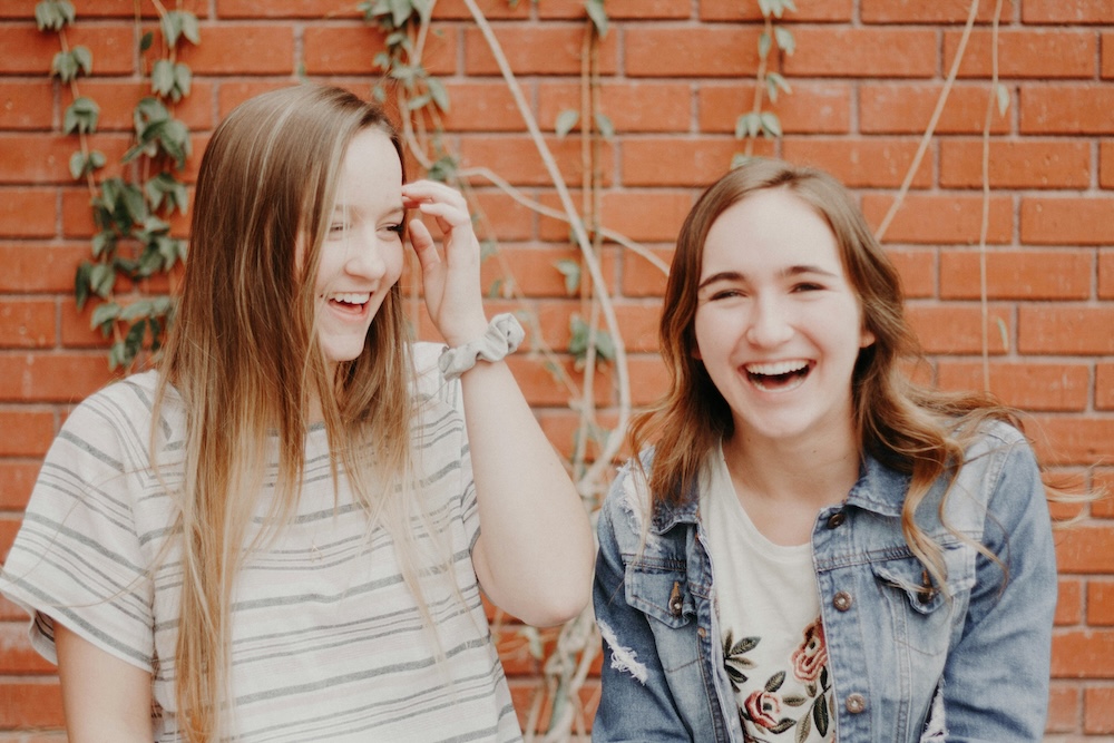 Two women smiling after successful mental health treatment in San Diego.