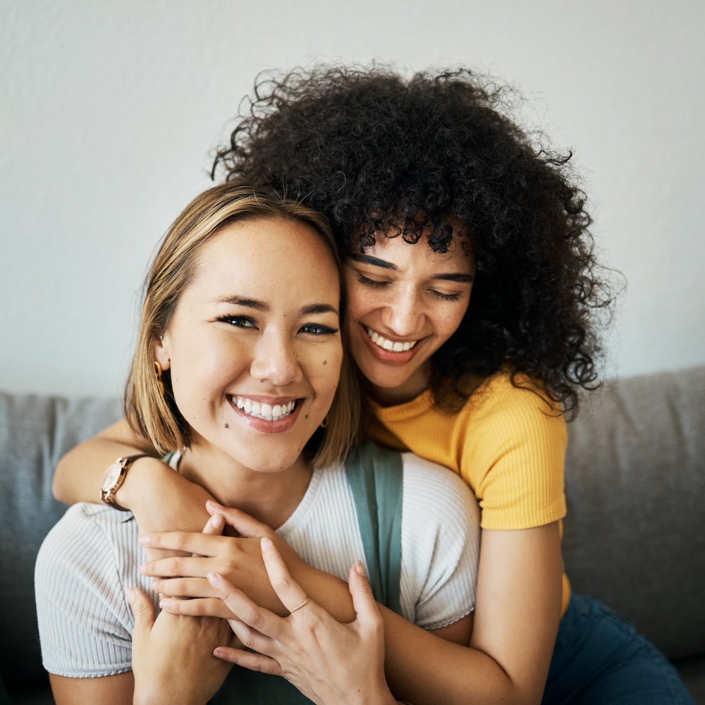 Women best friends smiling and hugging.