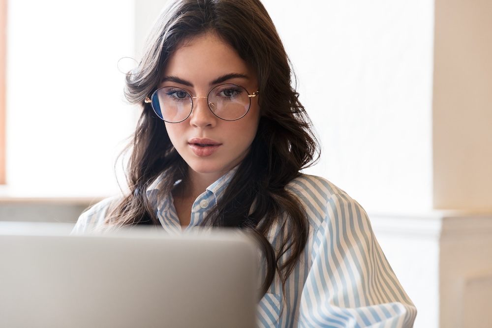 Young brunette woman on laptop