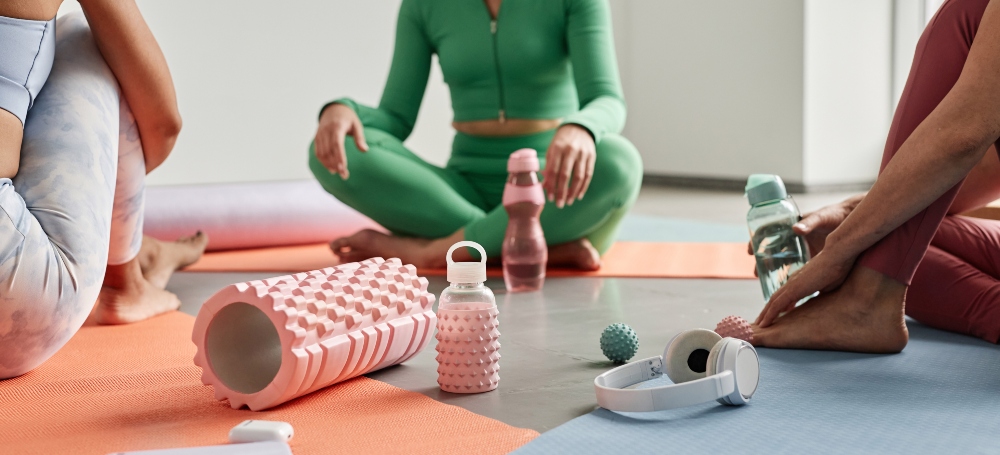 Close up of three women sitting on yoga mats