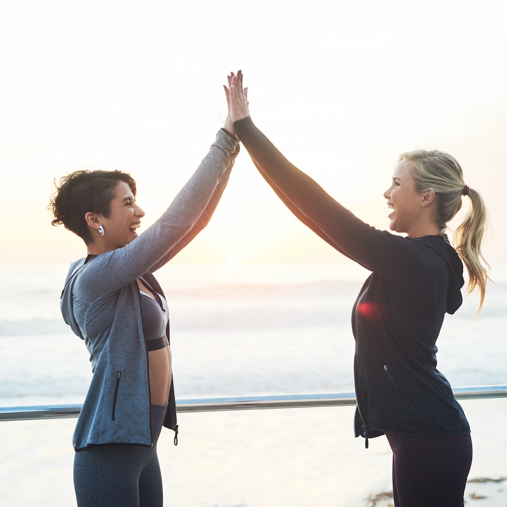 Two women high-fiving