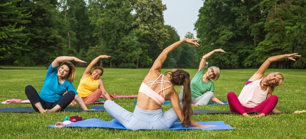 Group of women doing yoga in a park