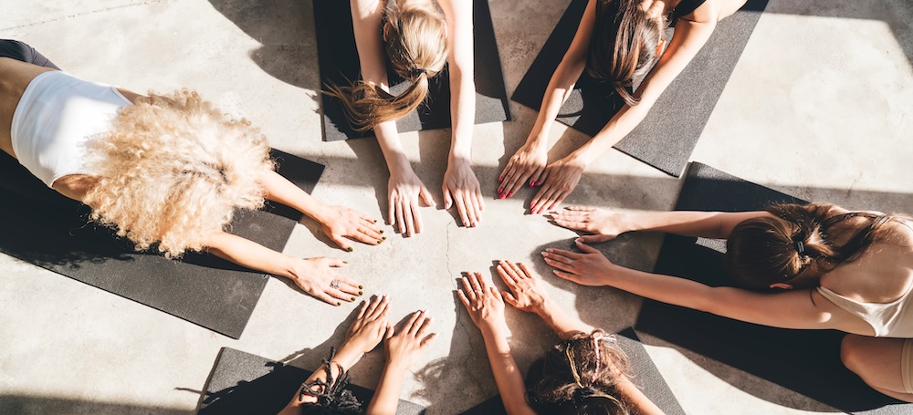 Group of women in a circle in childs pose