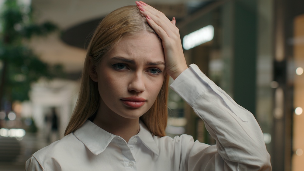 Upset woman with her hand on her head