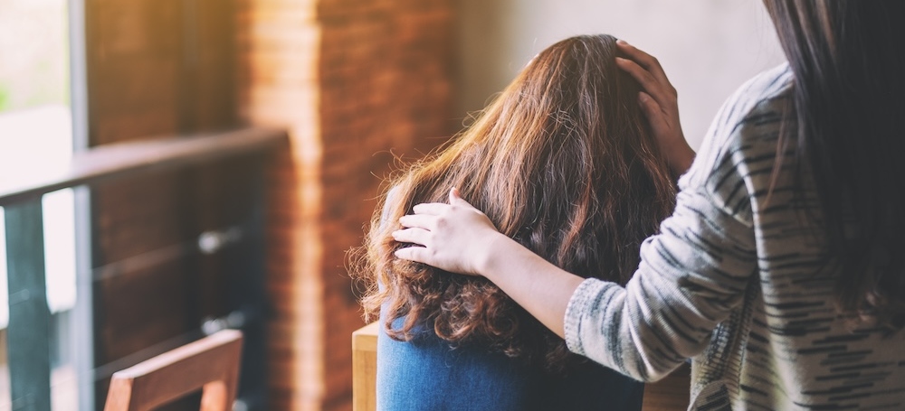 Woman comforting her sad friend