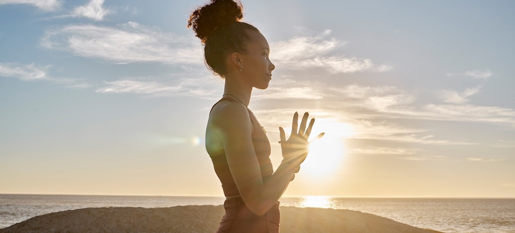 Yoga, meditation or sunset with woman in peace by the ocean, emphasizing the mind-body connection which applies to somatic therapy.